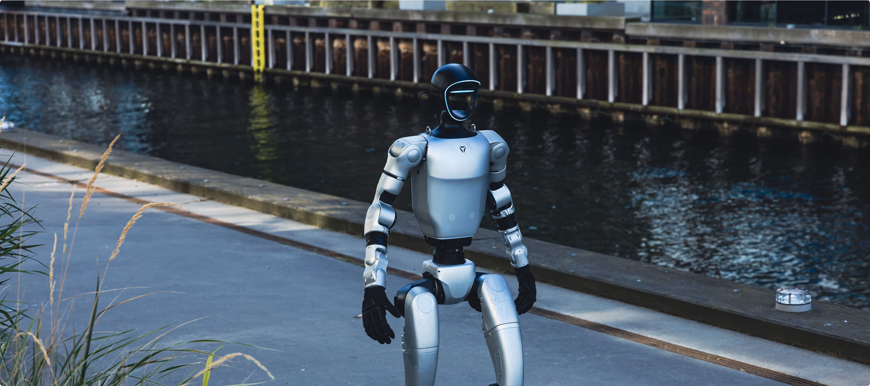A humanoid robot walking along a city waterfront